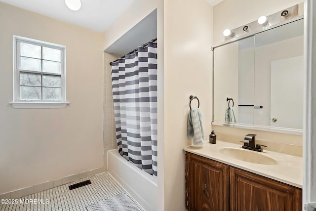 bathroom with shower / tub combo, vanity, and tile patterned flooring