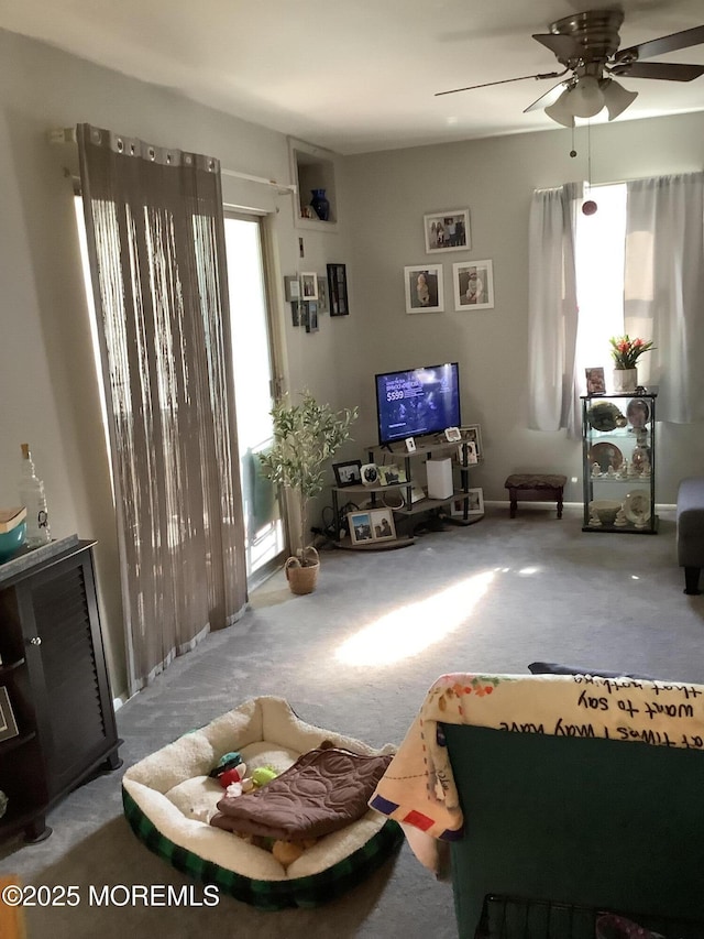 carpeted living room featuring ceiling fan