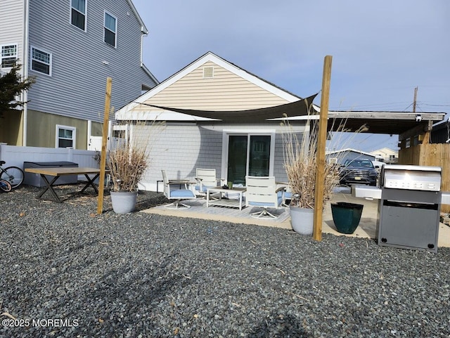 back of house with a patio