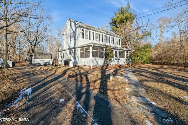 view of front of home with a sunroom