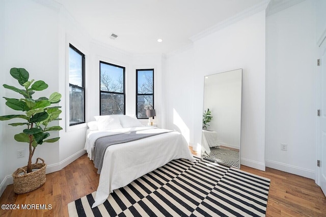 bedroom featuring dark hardwood / wood-style floors and ornamental molding