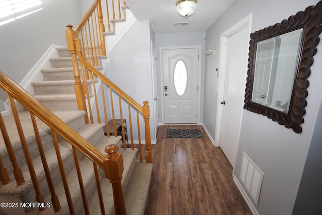 foyer entrance with dark hardwood / wood-style floors