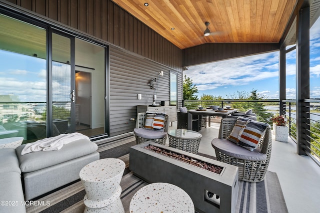 view of patio / terrace with a balcony and a fire pit