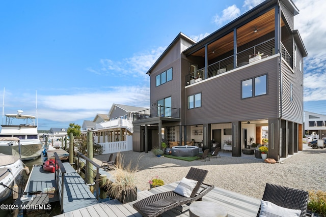 rear view of property featuring a balcony and a patio