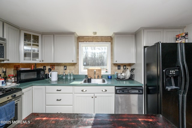 kitchen with tasteful backsplash, sink, black appliances, and white cabinets