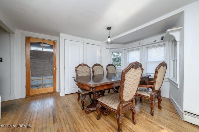 dining room with baseboard heating and light hardwood / wood-style floors