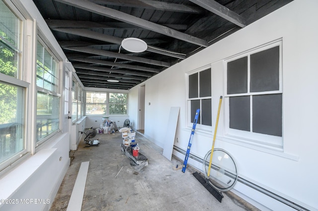 unfurnished sunroom with a baseboard heating unit