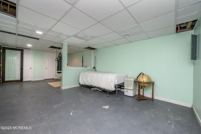 interior space featuring a paneled ceiling and electric panel