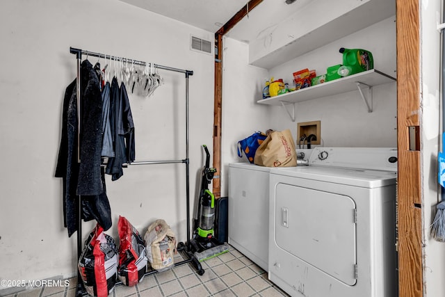 clothes washing area featuring independent washer and dryer