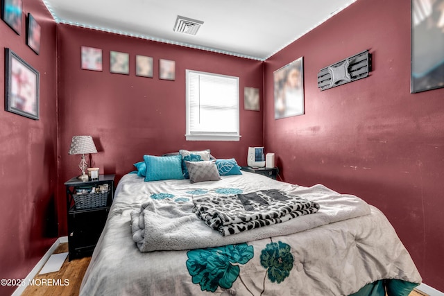 bedroom with hardwood / wood-style floors