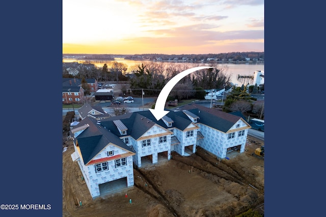 aerial view at dusk with a water view