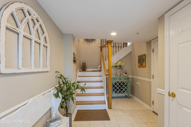 stairway featuring tile patterned flooring