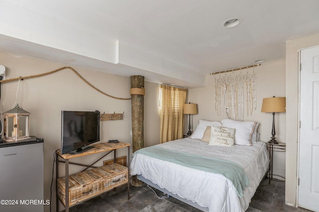 bedroom with stainless steel fridge