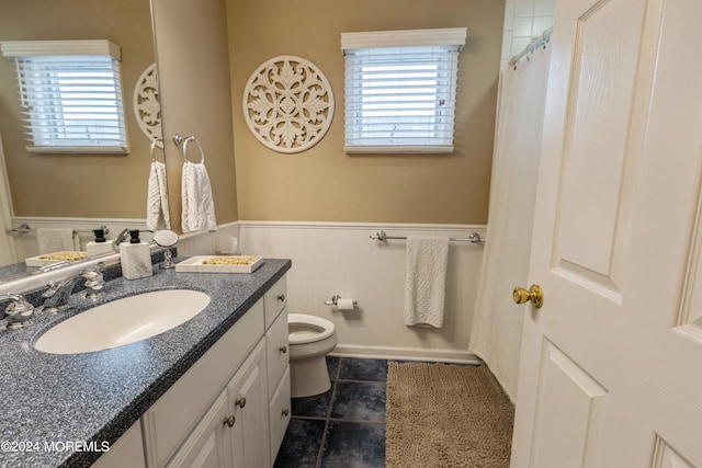 bathroom featuring toilet and vanity