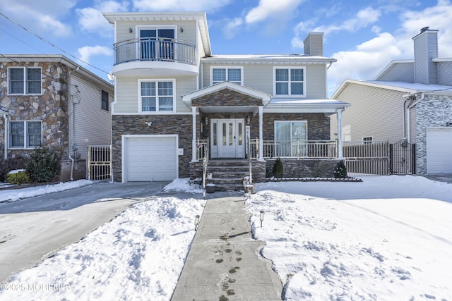 view of front of home featuring a porch and a garage