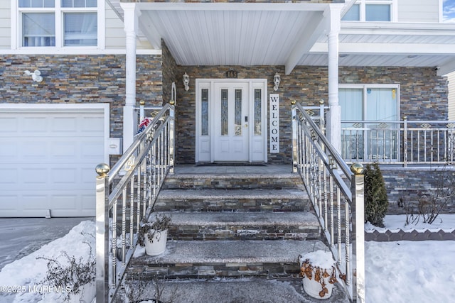 doorway to property with a garage and covered porch