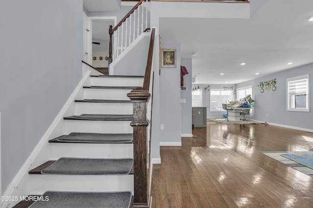 staircase with hardwood / wood-style floors