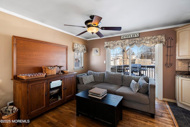 living area with dark wood finished floors, a ceiling fan, and crown molding