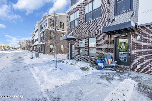 view of snow covered rear of property