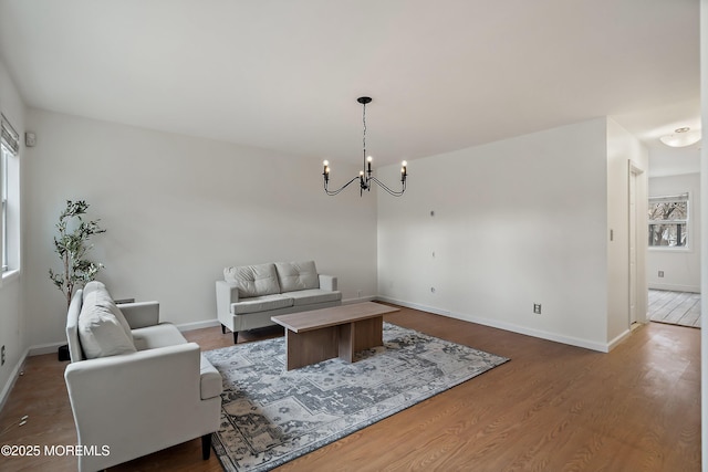 living room with hardwood / wood-style flooring and an inviting chandelier