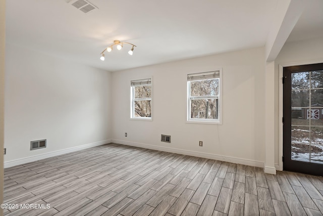 empty room with light hardwood / wood-style floors