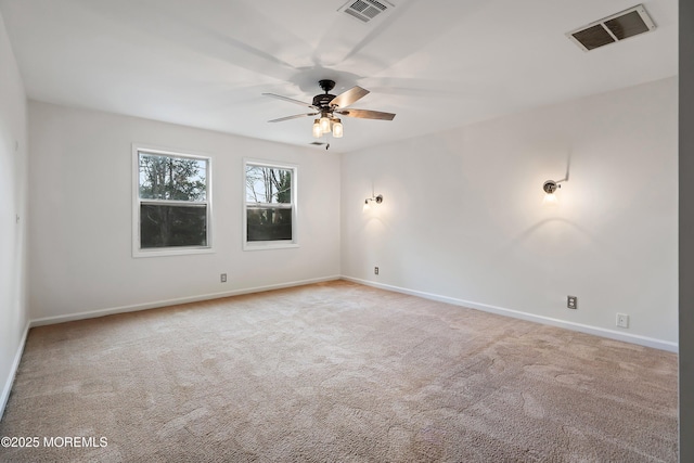 carpeted spare room featuring ceiling fan