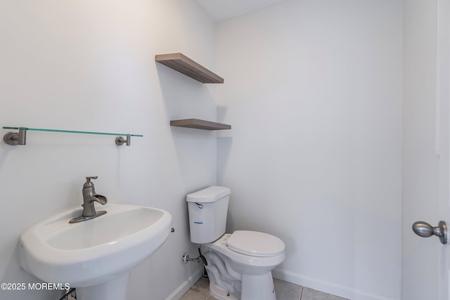 bathroom featuring sink, toilet, and tile patterned flooring