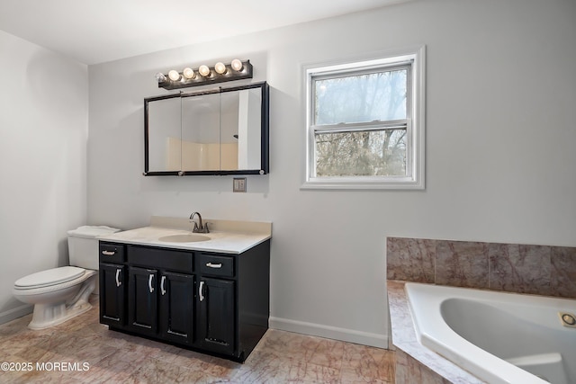 bathroom with toilet, a relaxing tiled tub, and vanity