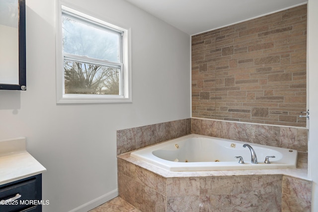 bathroom featuring vanity and a relaxing tiled tub