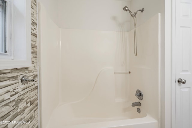 bathroom with decorative backsplash and shower / washtub combination