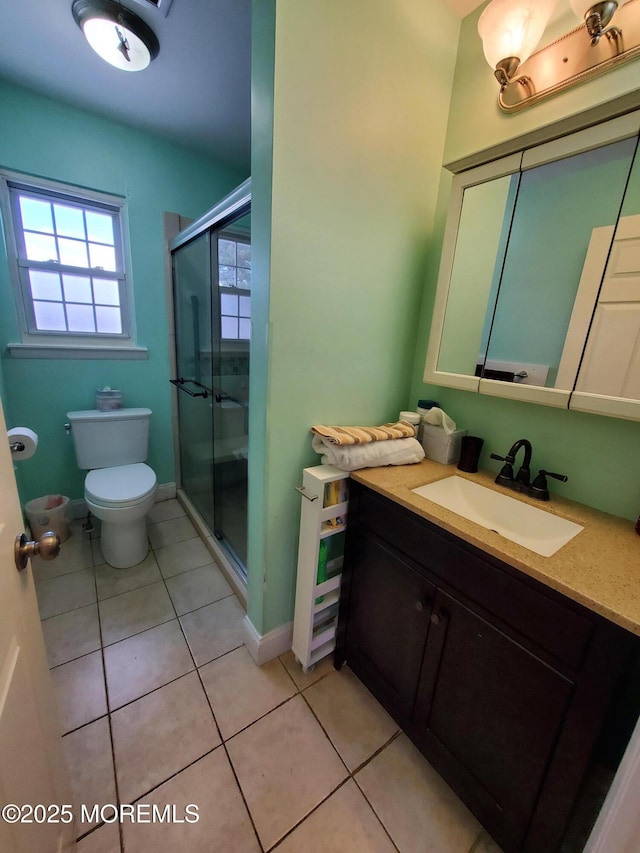 bathroom featuring toilet, tile patterned flooring, an enclosed shower, and vanity