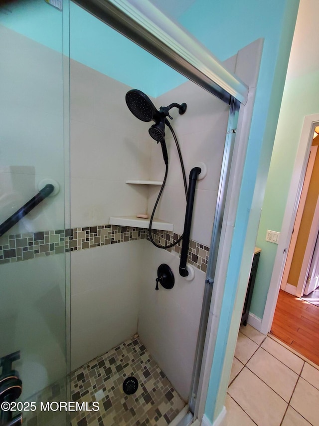 bathroom featuring walk in shower and tile patterned flooring