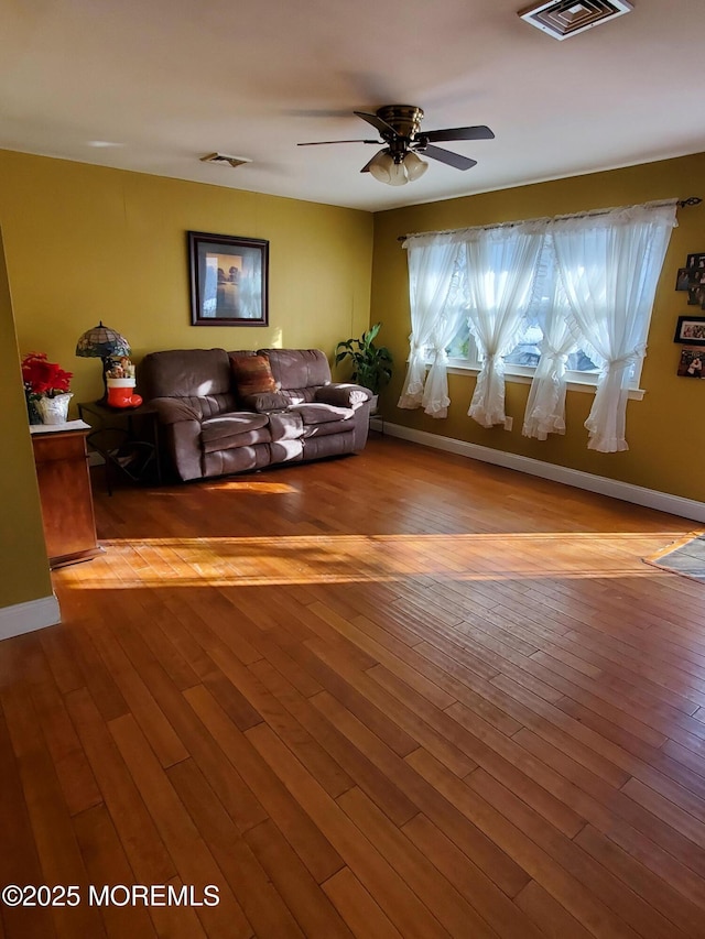 living room featuring ceiling fan and light wood-type flooring