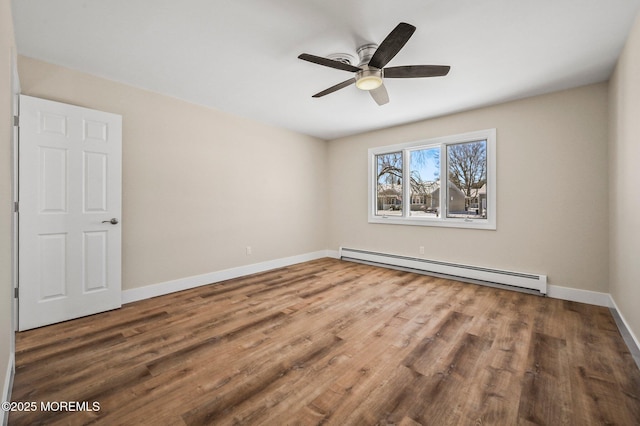 unfurnished room featuring ceiling fan, a baseboard radiator, and wood-type flooring