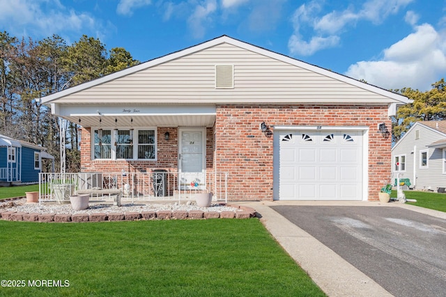 view of front of home featuring a garage, a front yard, and a porch