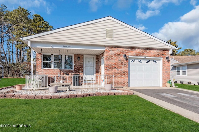 view of front of property featuring a garage, a front lawn, and covered porch