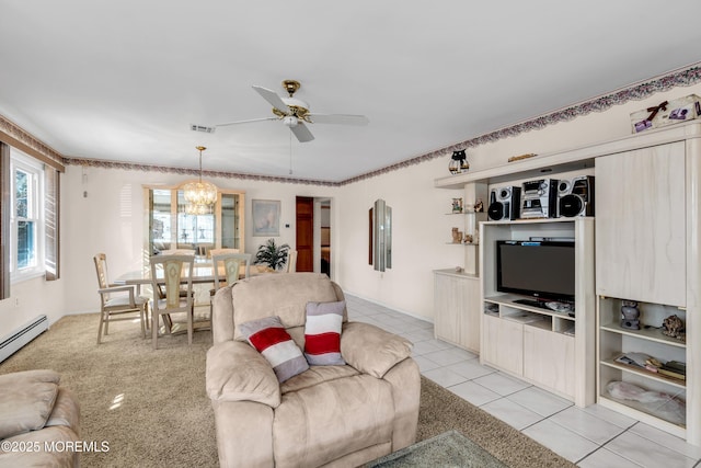 living room featuring ceiling fan with notable chandelier, a baseboard radiator, and light tile patterned flooring