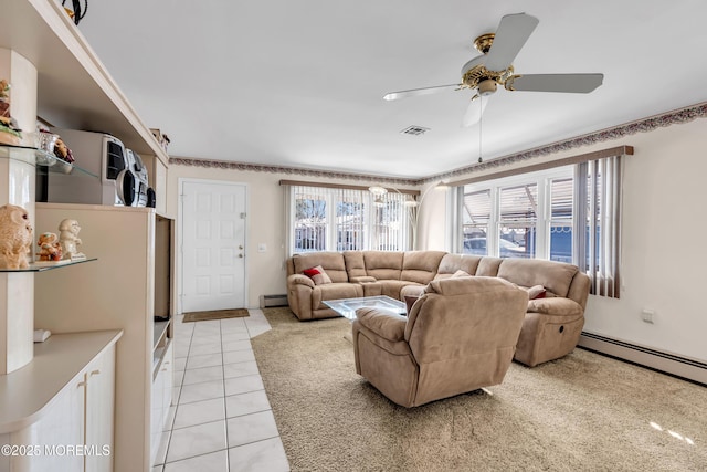 living room with a baseboard heating unit, ceiling fan, and light tile patterned flooring