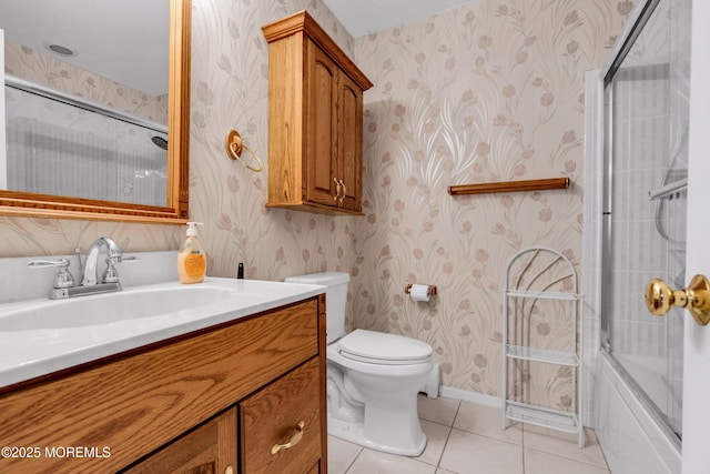 full bathroom with tile patterned flooring, vanity, shower / bath combination with glass door, and toilet