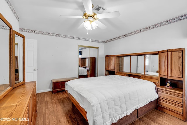 bedroom with wood-type flooring, ceiling fan, and a closet