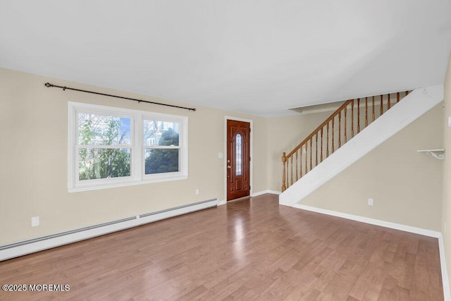 entrance foyer with hardwood / wood-style floors and a baseboard radiator