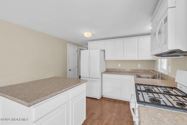 kitchen featuring light hardwood / wood-style floors, sink, white appliances, and white cabinets