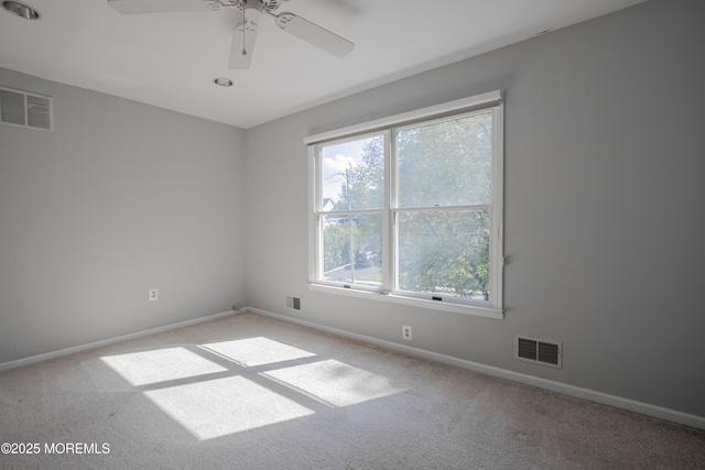 empty room featuring carpet and visible vents