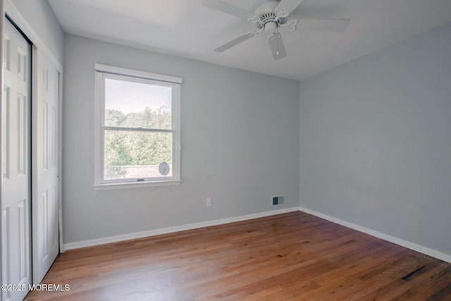 unfurnished bedroom featuring light wood-style flooring, visible vents, and baseboards