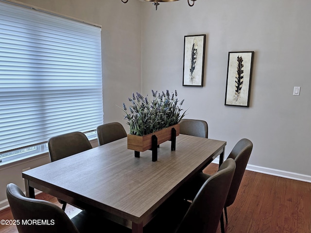 dining room featuring dark wood-style floors and baseboards