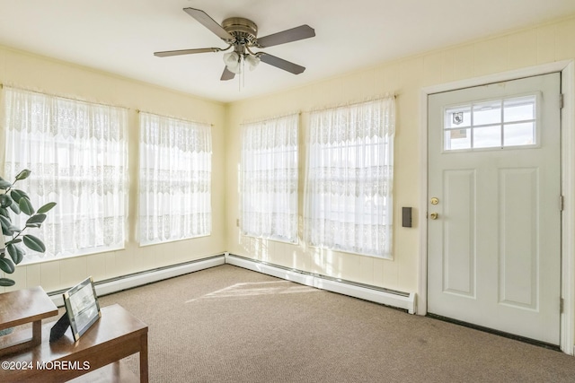 foyer with ceiling fan and carpet flooring