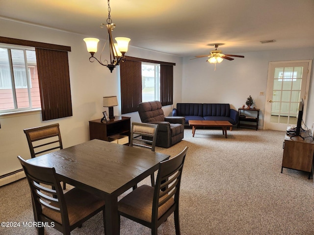 dining space with a baseboard heating unit, ceiling fan with notable chandelier, and carpet floors