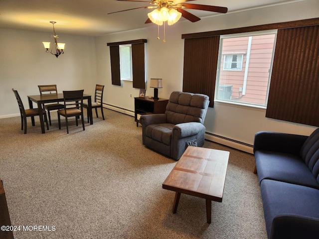 carpeted living room with baseboard heating and ceiling fan with notable chandelier