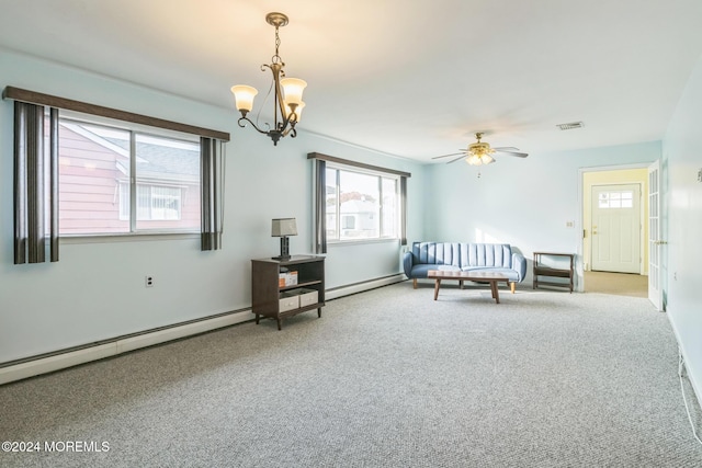 interior space with a baseboard heating unit, ceiling fan with notable chandelier, and carpet flooring