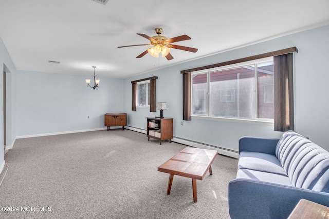 carpeted living room with ceiling fan with notable chandelier and a baseboard heating unit